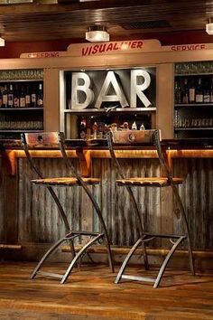 two chairs sitting in front of a bar