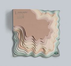 a wall mounted calendar with an abstract design on the front and back of it, in pastel tones