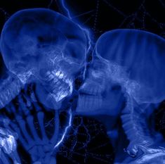 two people are kissing in the dark with blue lights on them and one is holding his head