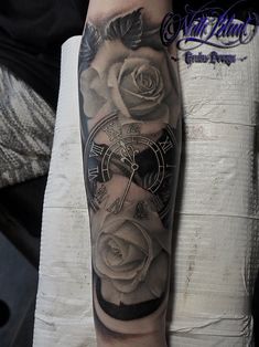 a man with a clock and roses tattoo on his arm