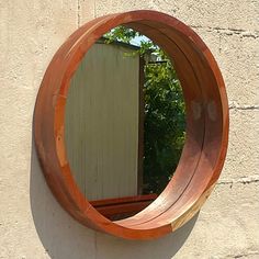 a circular mirror mounted to the side of a wall