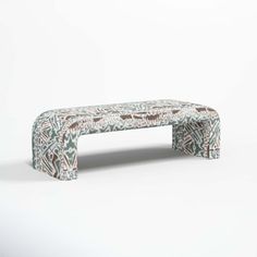 a bench made out of upholstered fabric with an intricate pattern on the back