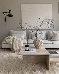 Hygge is a way of living that was originally developed by the Danish in the 18th century. No considered a defining feature of Danes' cultural identity, this interior design style is gaining popularity. In this Hygge beige living room, we can see all the elements. Candles for perfume, a black wall lamp for ambient lighting, textures in the furry rug and vase. Hygge is all about minimalist styling and this living room styling does exactly that. Click the pin to read more about hygge styling. Diy Bedroom, Marie Kondo, Ideas Living Room, Room Decorations, Wallpaper Living Room