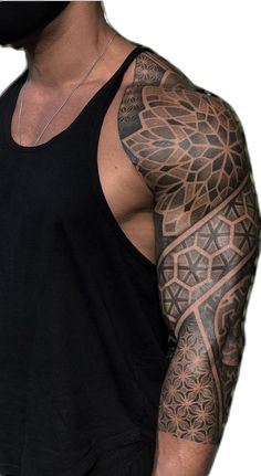 a man with tattoos on his arm and shoulder