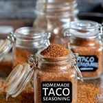 several jars filled with taco seasoning sitting on top of a table