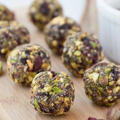 several balls of food sitting on top of a wooden cutting board