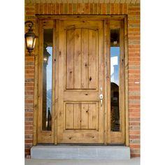 a wooden door with two sidelights on the outside