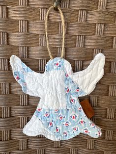 an angel ornament hanging on a wicker wall