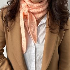 a woman wearing a pink scarf around her neck