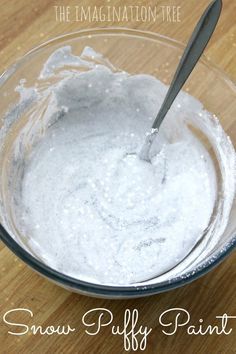 a bowl filled with snow puffy paint on top of a wooden table