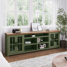 a living room with a large green entertainment center in it's centerpieces