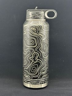 a silver can with a black and white design on it