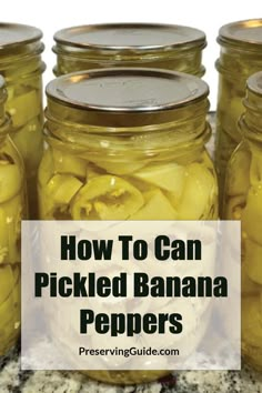 jars filled with pickled bananas sitting on top of a counter