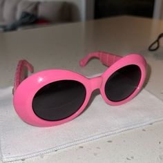 a pair of pink sunglasses sitting on top of a table