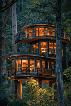 a tree house in the middle of a forest with lots of lights on it's windows