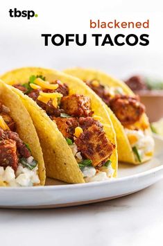 three tacos on a white plate with the words blackened tofu tacos