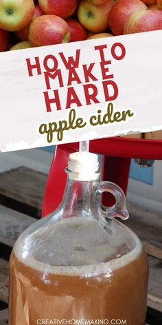 an apple cider sitting on top of a table with apples in the background and text how to make hard apple cider