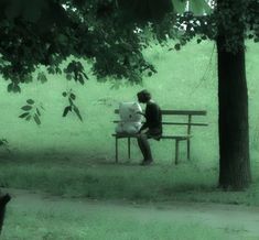 a person sitting on a bench in the park