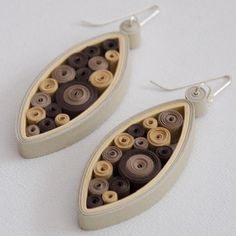 two pairs of earrings with buttons on them