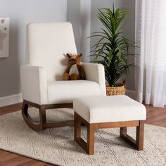 a teddy bear sitting in a white chair next to a potted plant on a rug