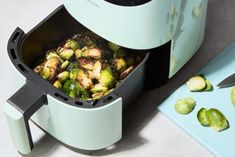 brussel sprouts are being cooked in an air fryer