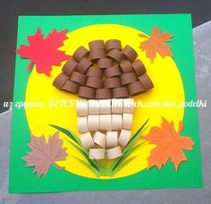 a paper fall scene with leaves and marshmallows