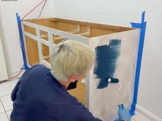 a man painting the walls in his home