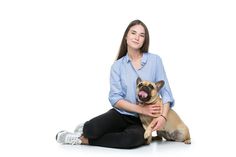 a woman sitting on the floor with her dog and posing for a photo in front of white background