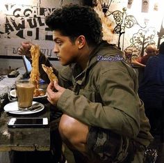 a man sitting at a table eating food