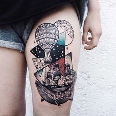 a woman's thigh with an anchor and hot air balloon tattoo on it