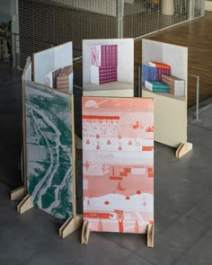 three bookshelves are stacked on top of each other in front of a building