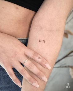 a woman's arm with two small tattoos on the left side of her body