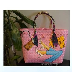 a pink handbag with an image of a woman's feet on it