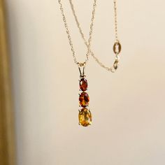 **PENDANT ONLY. NO CHAIN INCLUDED** 14KT yellow gold graduated size genuine Citrine gemstone pendant. Pendant measures: 18mm x 5.2mm Chain passage measures: 4.7mm x 3.5mm Tapered bail Pendant includes:  (1) 5mm x 3mm oval Madeira Citrine (1) 6mm x 4mm oval Citrine (1) 7mm x 5mm oval  Beautiful, warm orange/red tones! Citrine is the birthstone for November babies + this pendant makes a TERRIFIC gift!  Also makes a great gift for Christmas, holidays, birthdays, or as a self-appreciation gift!  Matching earrings are sold separately! Check out all our Citrine jewelry pieces + entire jewelry collection! Please let us know if you have any questions. Thank you, Legacy Saint Jewelry FOLLOW US ON INSTAGRAM: @legacysaintjewelry -OUR RETURN POLICY-  To return an item you must first contact us within November Baby, Saint Jewelry, Citrine Jewelry, Citrine Pendant, Citrine Necklace, Citrine Gemstone, Yellow Gold Chain, Cross Charms, Star Pendant