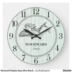 a clock with the words mermaid dolphin aqua blue beach by body english on it's face