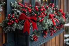 a christmas window box with holly and red berries on the windowsill is adorned with bows