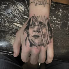 a man's hand with a tattoo on it