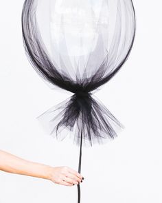 a person holding a black and white balloon