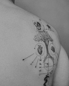 the back of a man's shoulder with an image of a tree on it