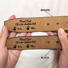 two brown leather belts with handwritten words on them, one for dad and the other for daughter