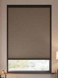 a living room with a large window covered in blinds