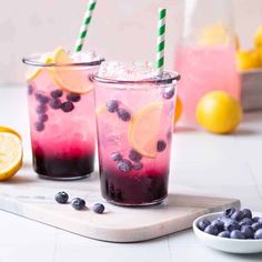 two glasses filled with blueberries and lemonade