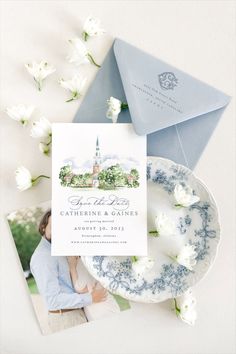 the wedding stationery is laid out on top of plates and napkins with flowers