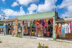 there are many colorful scarves on display in this street vendor's shopfront