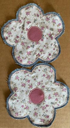 two flower appliques sitting on top of a cardboard box