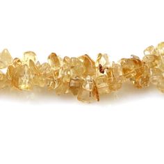 yellow citrine beads on white background