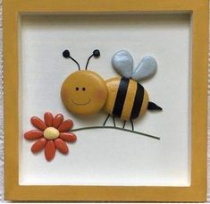 a yellow frame with a bee and flower in it