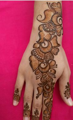 the hand is decorated with henna designs