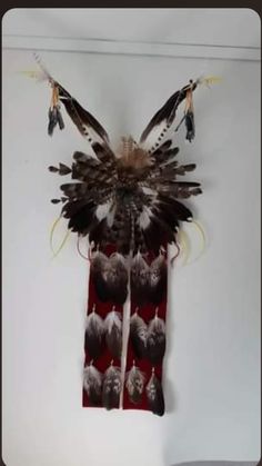 a wall hanging with feathers on it