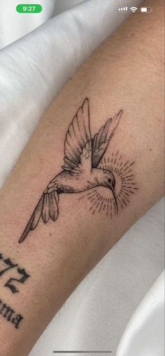 a small bird tattoo on the arm